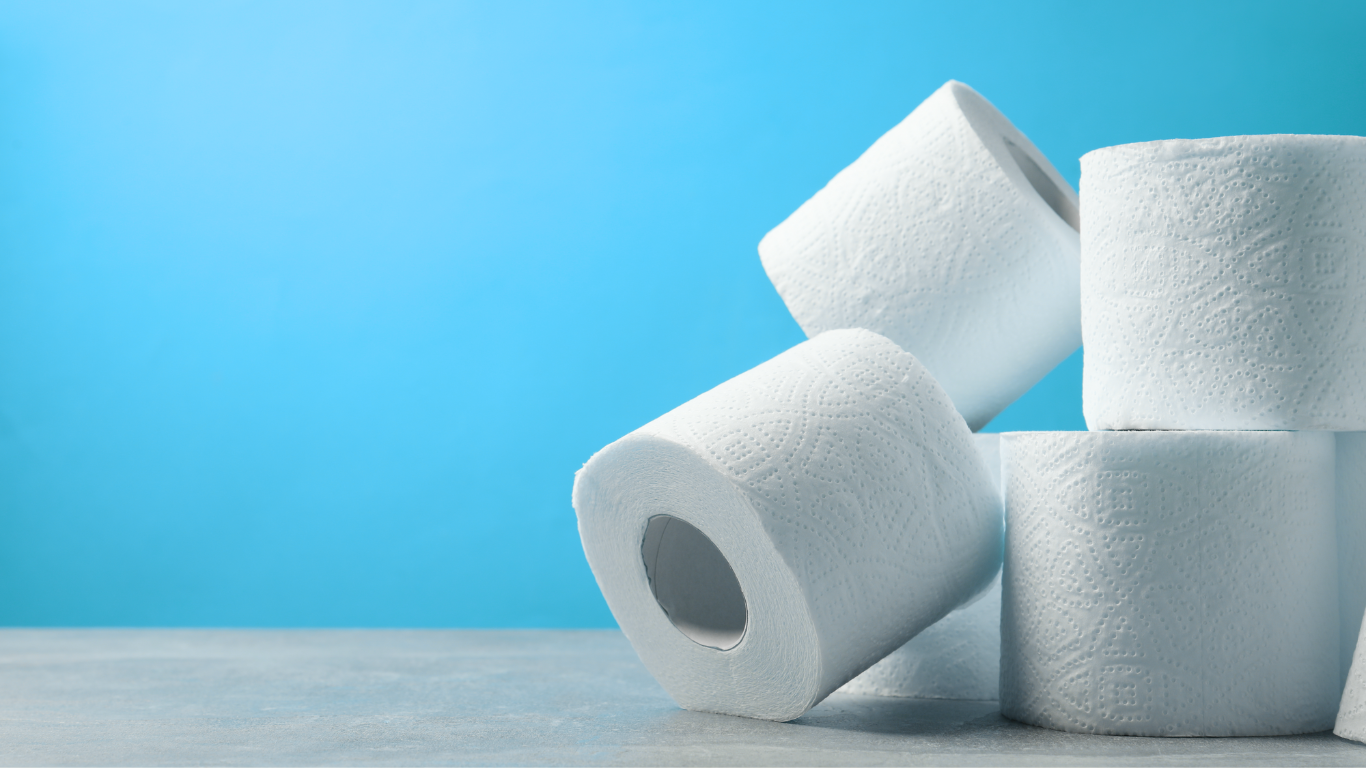 Toilet paper rolls on a turquoise background.